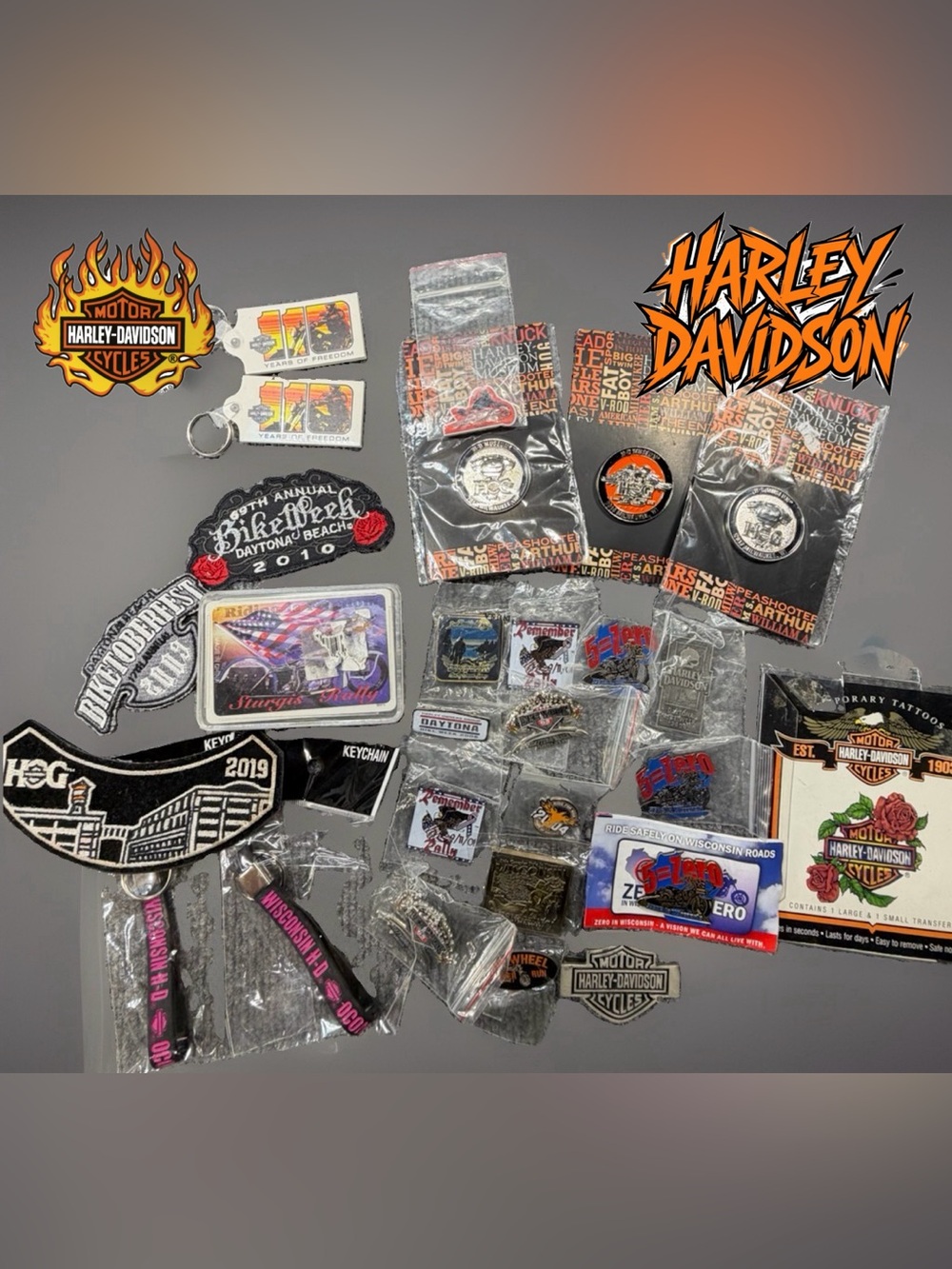 Assortment of pins, keychains, patches, cards. Most are new. Some are duplicates